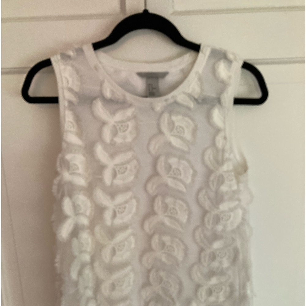 Sheer overlay with appliqués over white tank